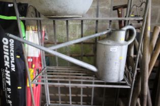 A long reach galvanised watering can lacking rose
