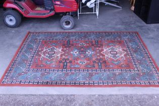 An approx. 7'5" x 5'3" blue and red patterned rug