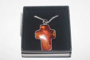 A large Hallmarked silver and amber cross on chain