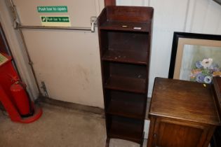 An oak open fronted bookcase of narrow proportions