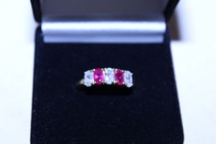 A silver gilt cubic zirconia and ruby coloured sto