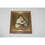 A brass framed miniature print of mother and child