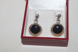 A pair of silver and onyx ear-rings