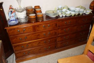 A yew wood sideboard fitted six graduated drawers