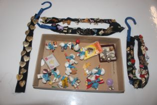 A box containing various badges, Smurf figures, dr