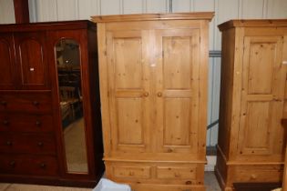 A pine wardrobe fitted single drawer below