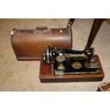 A Singer hand sewing machine in fitted case