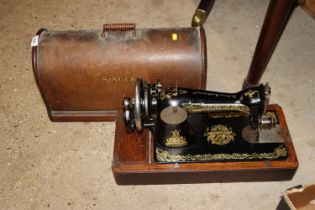 A Singer hand sewing machine in fitted case