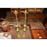 A pair of brass candlesticks, stamped "The Diamond