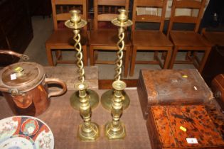 A pair of brass candlesticks, stamped "The Diamond