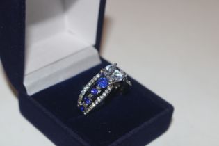 A dress ring set with blue and white stones