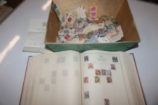 A stamp album and a quantity of loose stamps