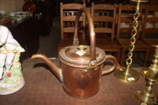 A copper watering can, with old repair to the spou