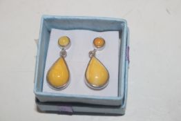 A pair of Sterling silver and butterscotch amber e