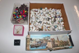 A box containing a collection of thimbles; various