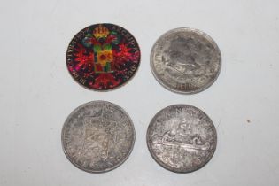 Four continental crown size silver coins including