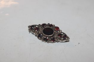 A vintage Sterling silver and garnet brooch