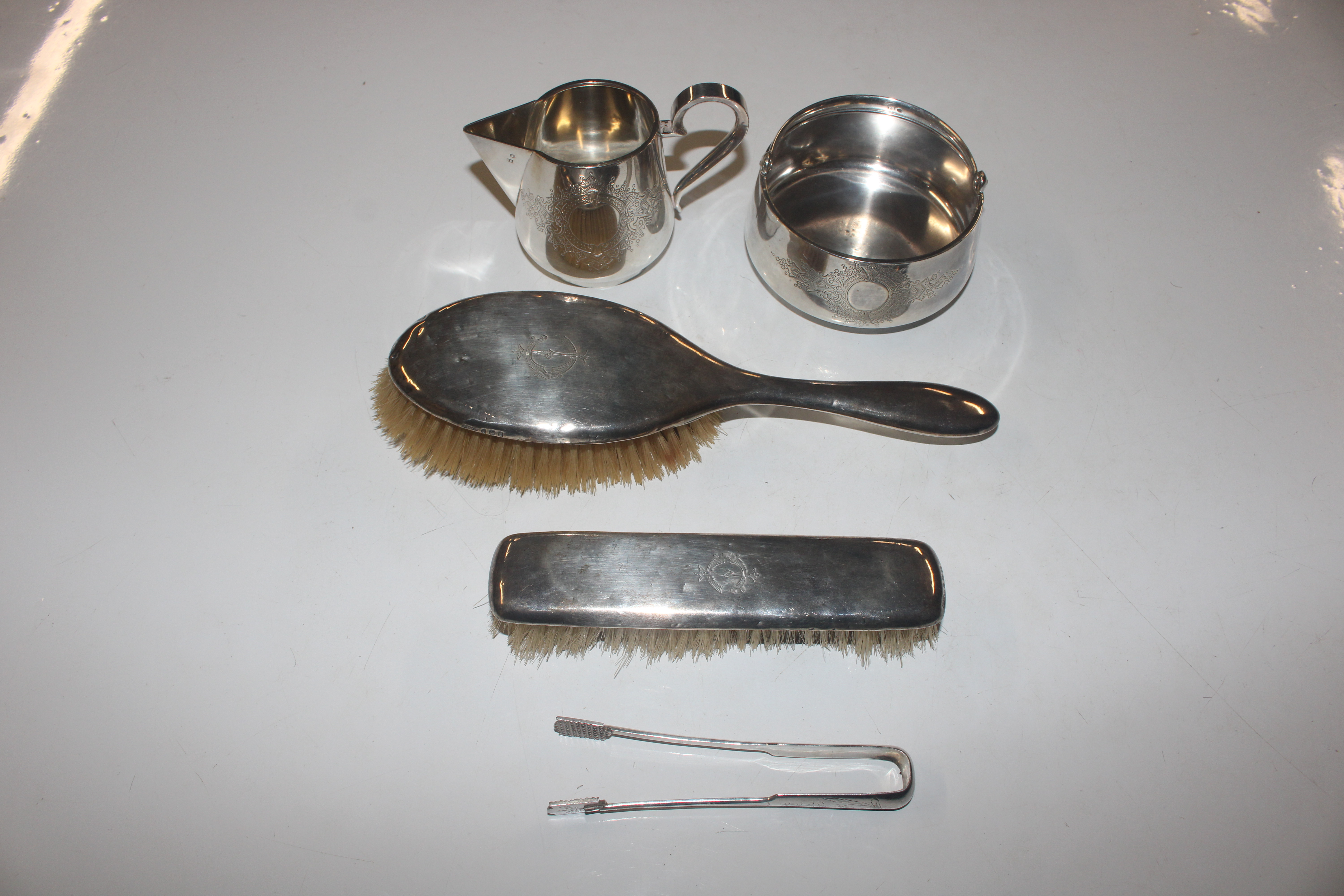 Two silver backed dressing table brushes; and a wh