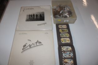 A Harlequin LP; an Evita LP; an album of cigarette