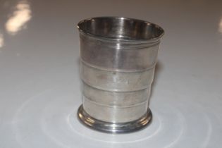 A white metal telescopic cup