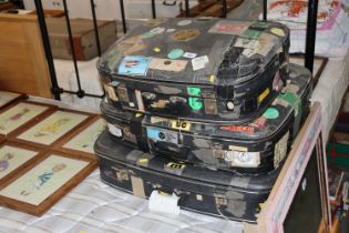 Three suitcases with travel labels and stickers