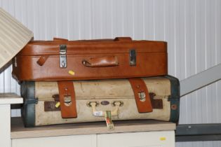 A Monarch suitcase together with another