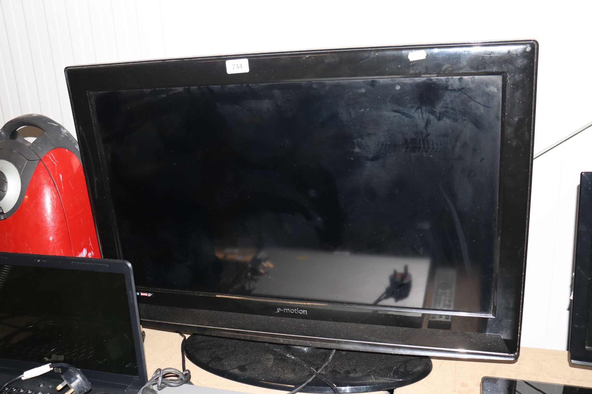 An E-Motion flat screen television lacking remote