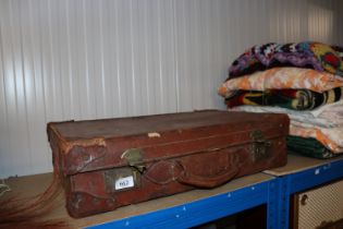 A vintage leather and brass mounted suitcase