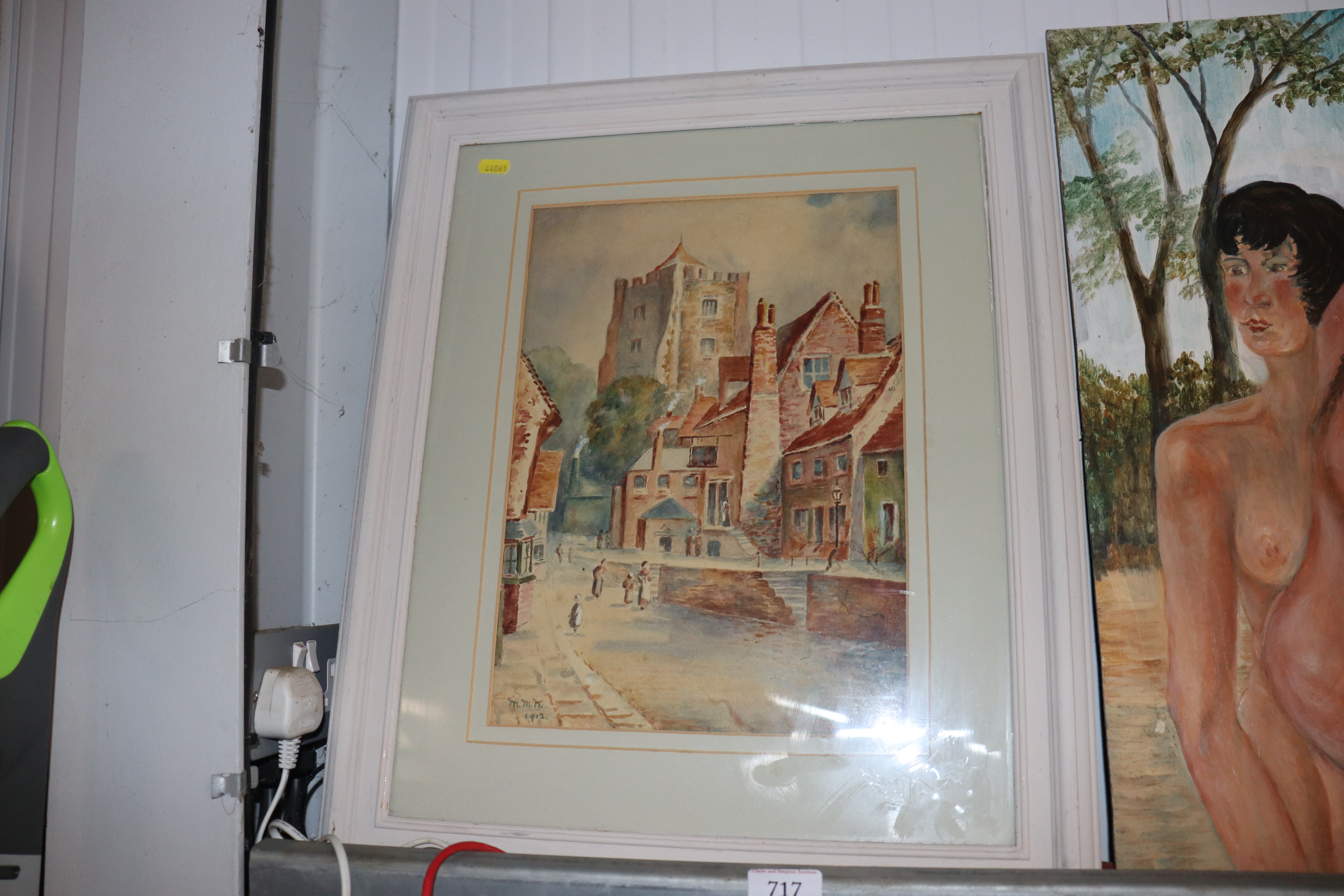 A framed watercolour study of a street scene, sign