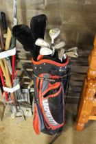 A Wilson golf bag and contents of clubs to include