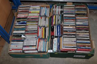 Two boxes containing various CDs