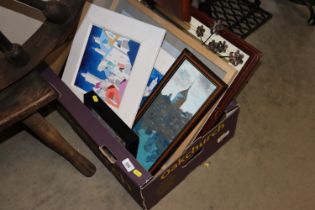 A box containing various pictures and prints to in