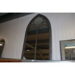 A wide arched outdoor mirror (82)