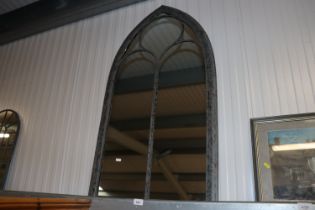 A wide arched outdoor mirror (82)