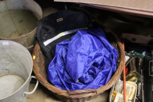 A wicker twin handled basket and a sleeping bag