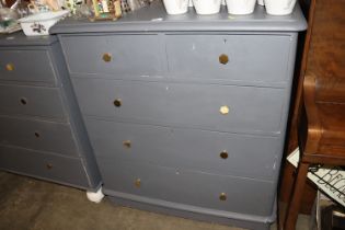 A grey painted pine chest fitted two short over th