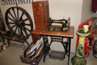 A Singer sewing machine on treadle base No.V320859