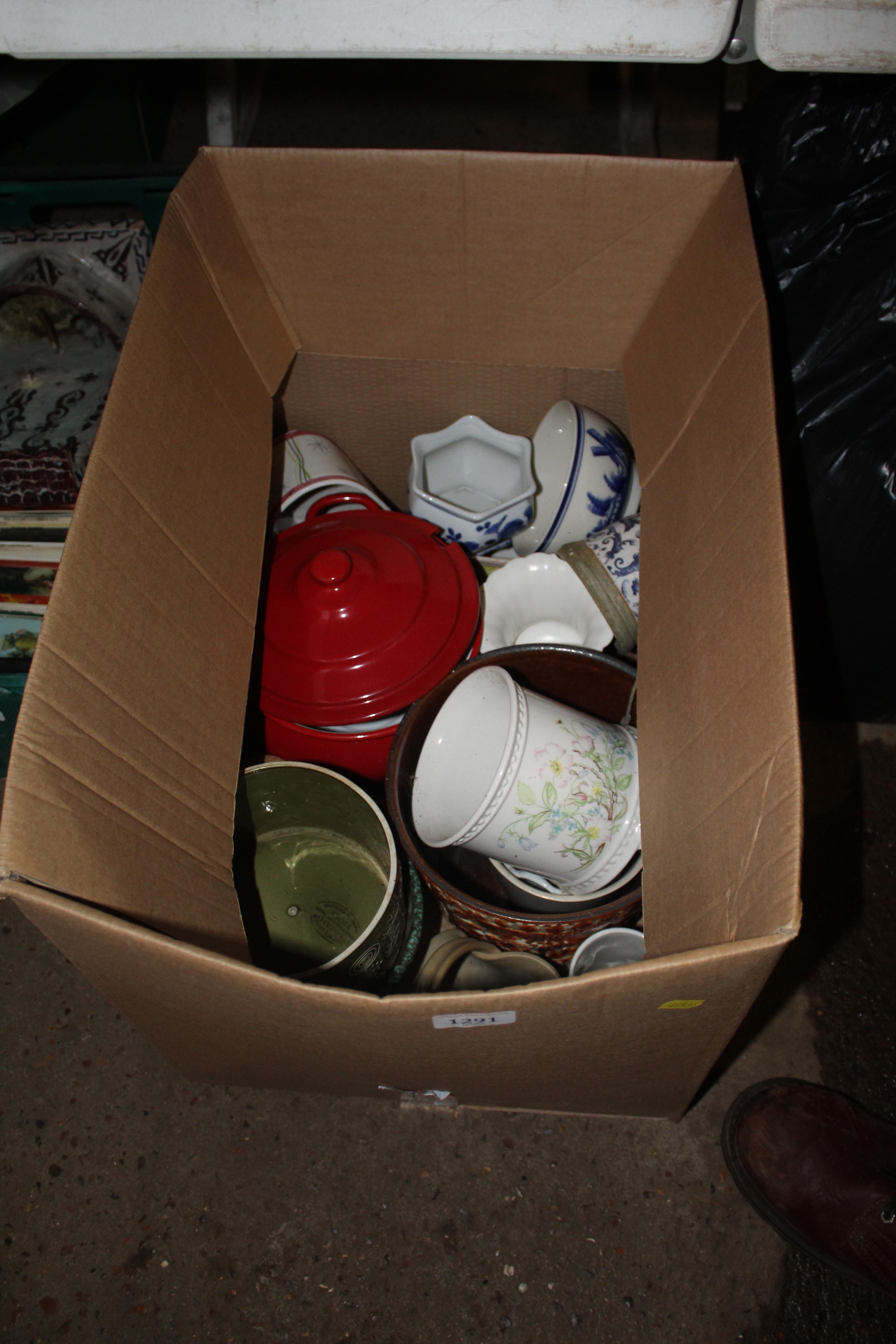 A box containing various plant pots, cooking pot e