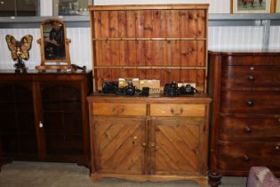 A pine dresser fitted two drawers on cupboard base