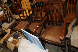 An oak elbow chair and two oak dining chairs