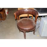A Victorian leatherette upholstered chair raised o