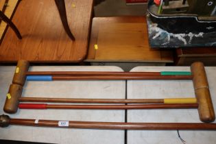 Four croquet mallets