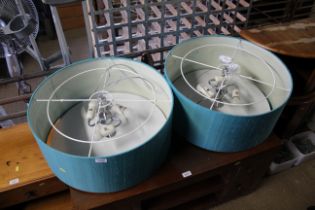 A pair of three bulb hanging ceiling lights with s