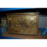 A brass coal box decorated with ships