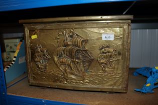 A brass coal box decorated with ships