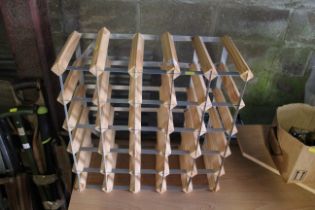 A wooden and metal 25 wine bottle rack