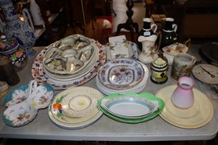 A collection of various patterned dinnerware; dish