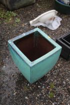 A large green glazed plant pot