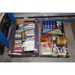Two boxes containing cassettes, DVDs, board games