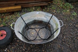 A large galvanised twin handled bath and a metal p